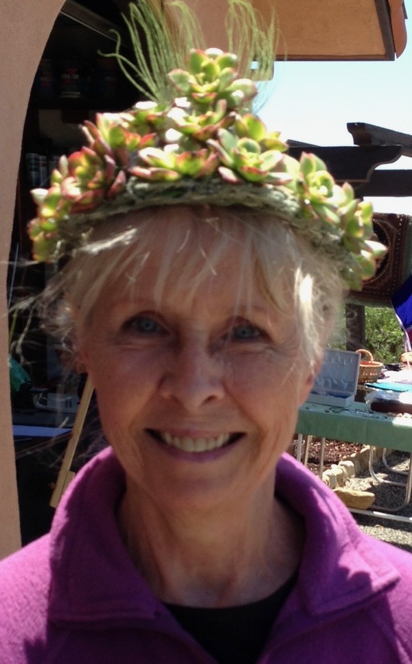 Lorraine Cestone, smiling, wearing a crown of succulents